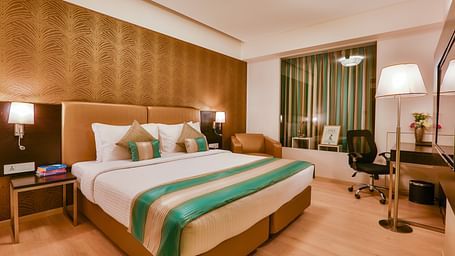 A room with a double bed and a work desk and chair at T24 Residency, Andheri East, Mumbai