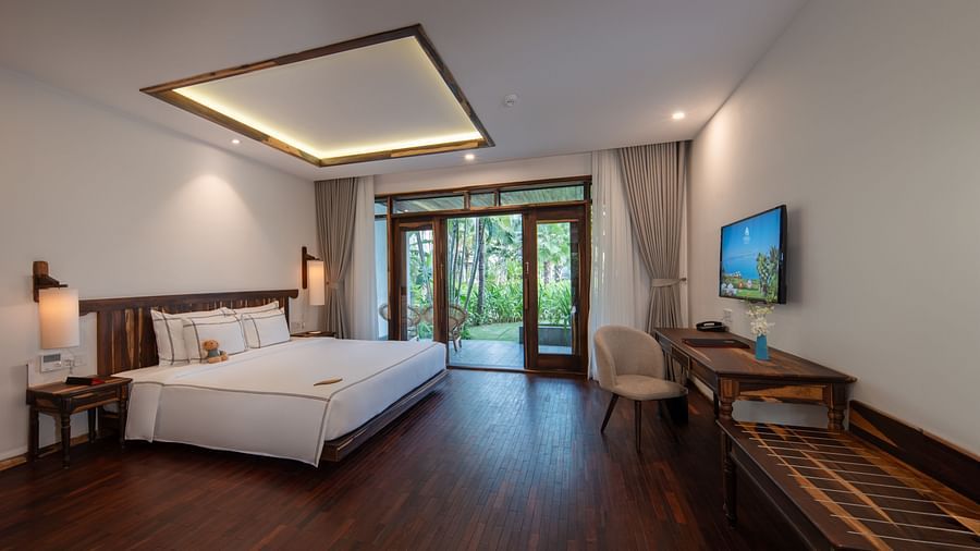 An image of a well furnished bedroom with a balcony - Alibu Resort Nha Thrang