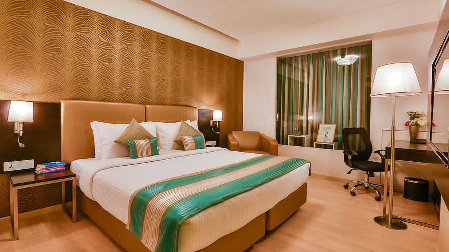 A room with a double bed and a work desk and chair at T24 Residency, Andheri East, Mumbai