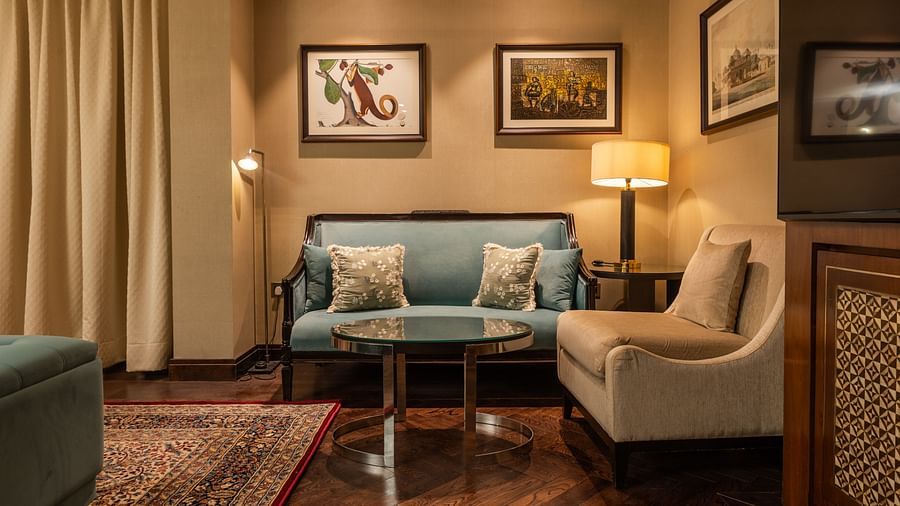 image of a compact seating area at a corner of our cabana room with a standing lamp - The Claridges New Delhi