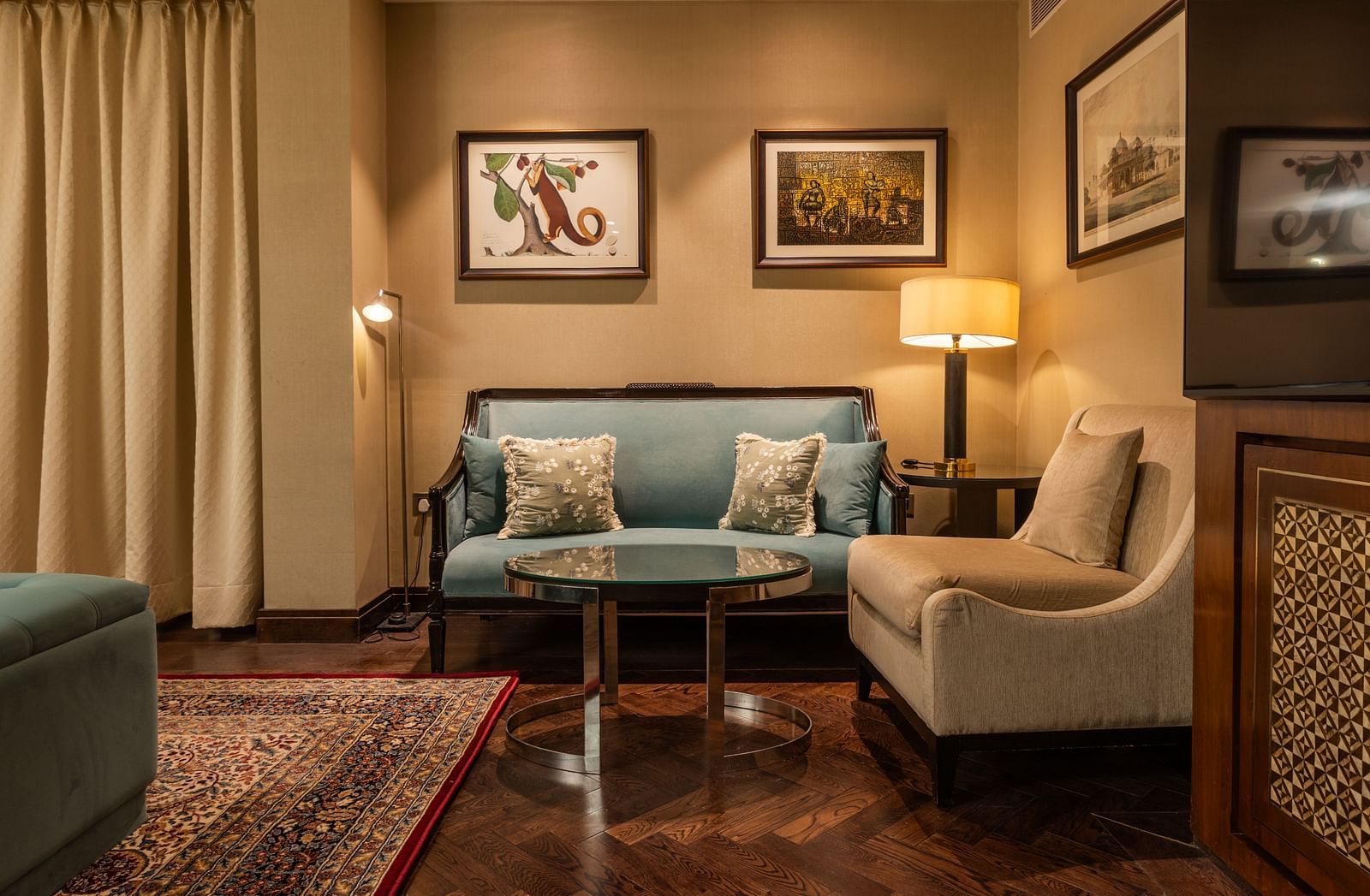 image of a compact seating area in the corner of the Cabana Room, featuring a standing lamp - The Claridges New Delhi