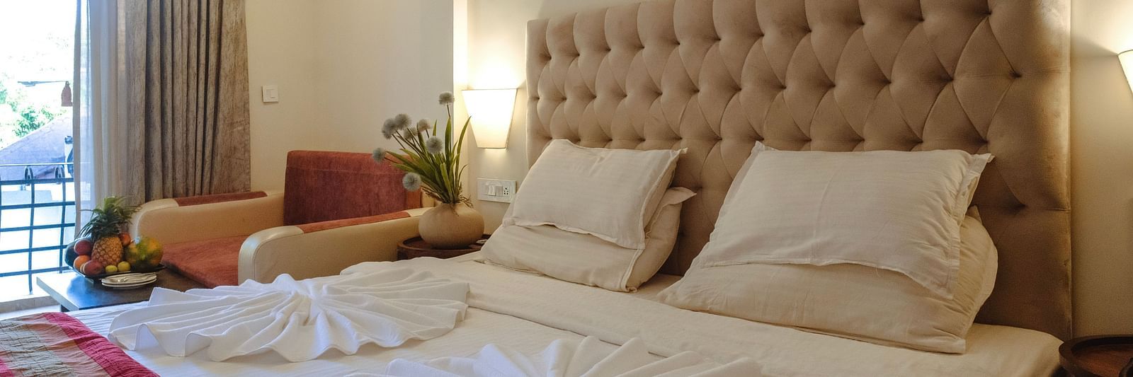 A neatly arranged bedroom with towel art on the bed and soft ambient lighting – The Verda de Miranda Resort.