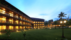 The building of Uday Backwater Resort lit up in warm lights during late evening