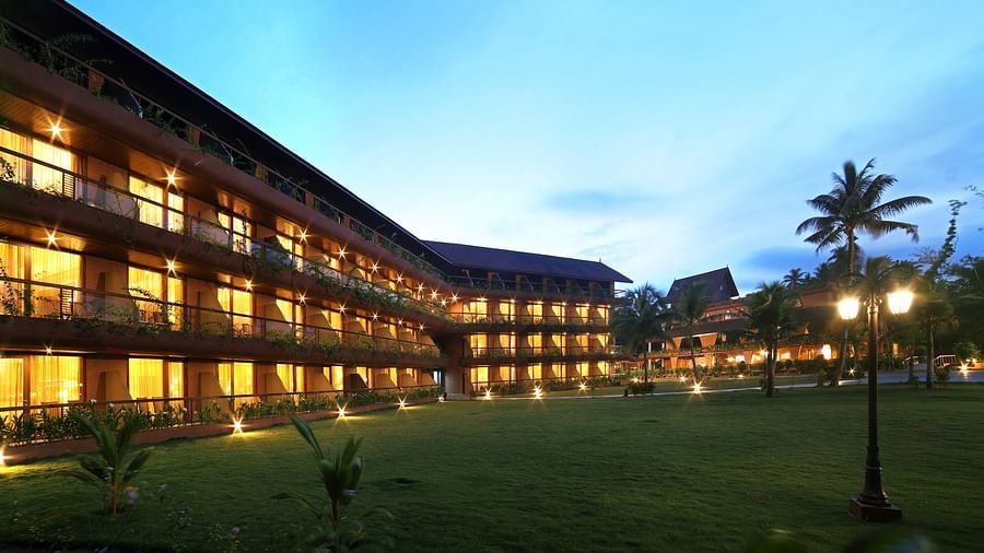 The building of Uday Backwater Resort lit up in warm lights during late evening