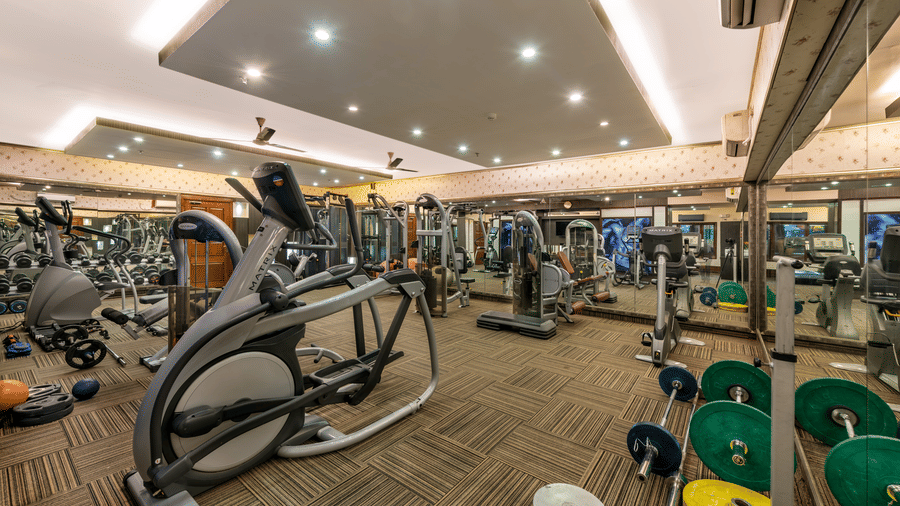Well-equipped gymnasium at Mayfair Lagoon, Bhubaneswar, featuring modern cardio and fitness machines with spacious interiors and bright lighting