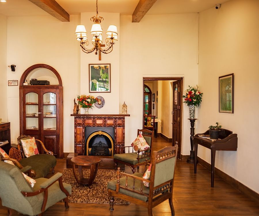 room with a central fireplace and comfortable seating space