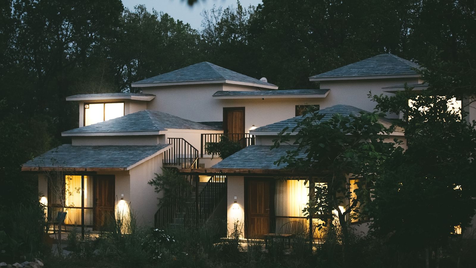 Exterior of the villas at Saraca Resort & Spa Corbett during night time