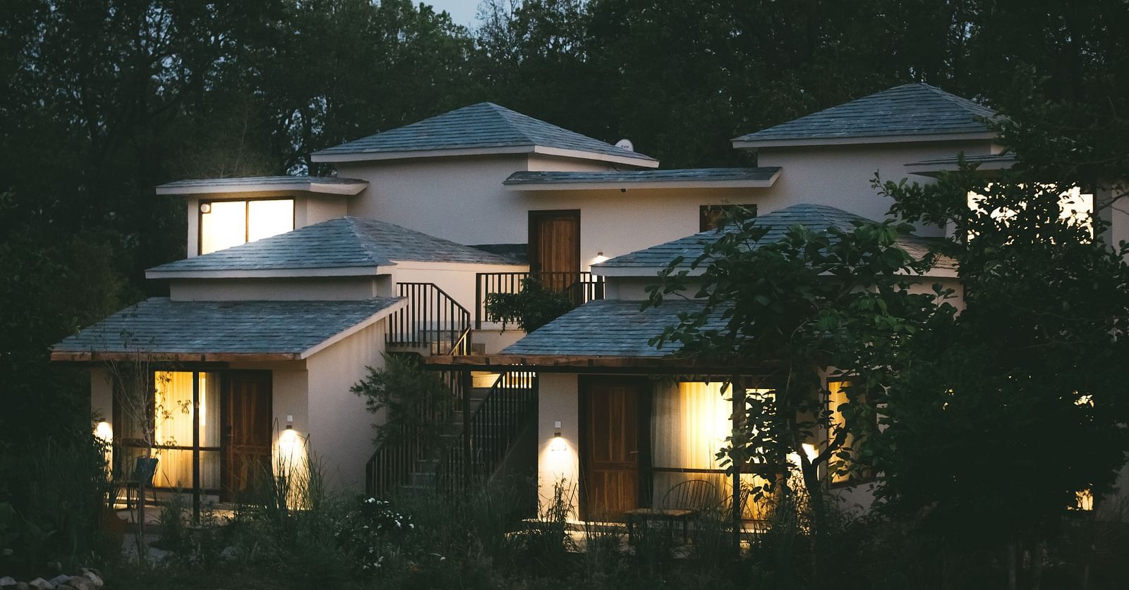 Exterior of the villas at Saraca Resort & Spa Corbett during night time