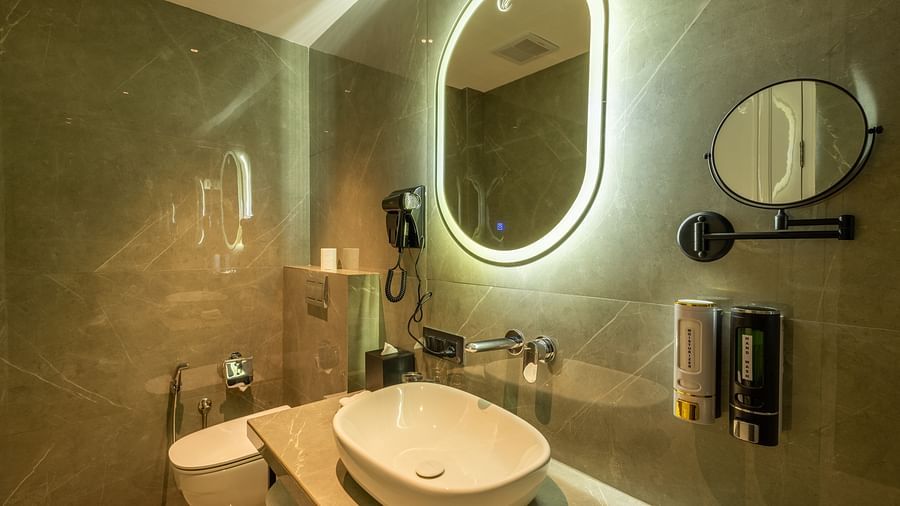 A mirror and wash basin in the washroom | Renest Calangute, Goa
