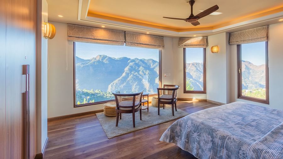 The Manor Shimla - The interiors of a room with a sitting area overlooking the mountains