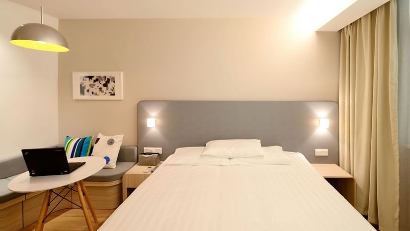 an image of a bedroom with a light hanging from the ceiling