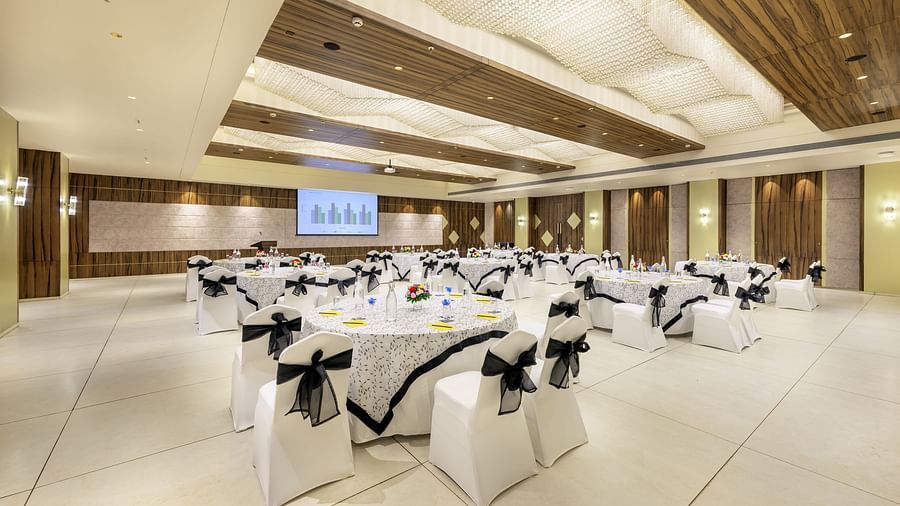 Spacious event hall at Golden Tulip, Candolim, Goa, showcasing modern lighting and formal seating.