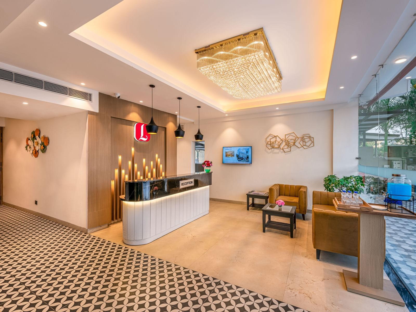 The elegant and well-lit lobby of a hotel with comfortable seating and a reception desk - Lords Hotels & Resorts