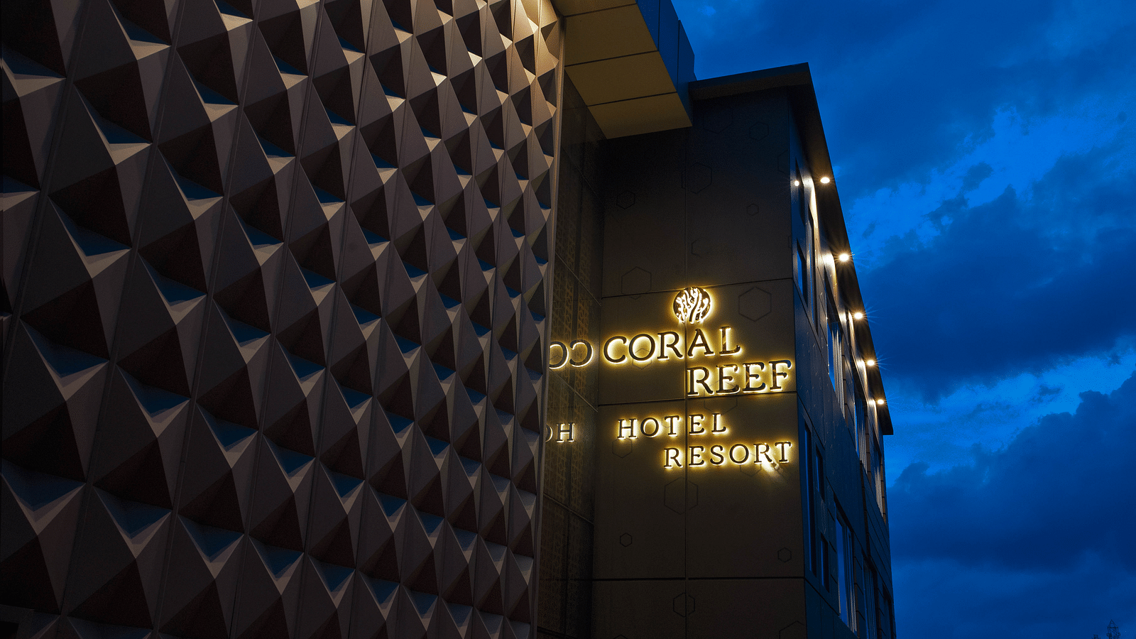 Image of facade of Coral Reef Hotel and Spa in Port Blair in the late evening as the sky is indigo