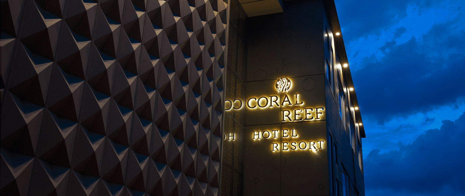 Image of facade of Coral Reef Hotel and Spa in Port Blair in the late evening as the sky is indigo