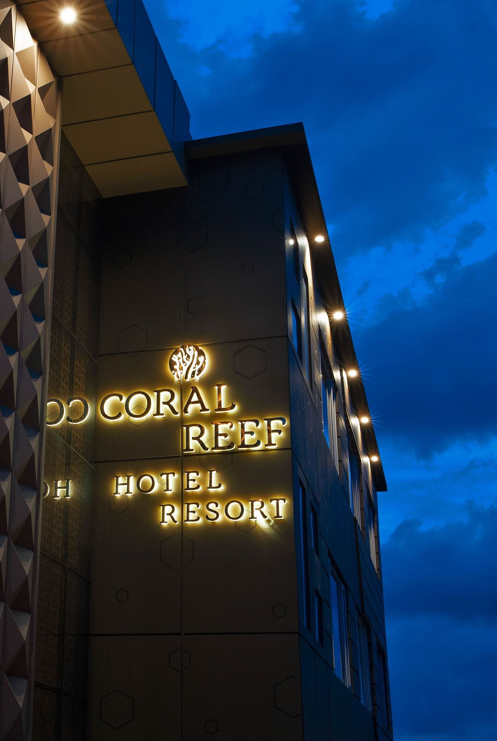 Image of facade of Coral Reef Hotel and Spa in Port Blair in the late evening as the sky is indigo