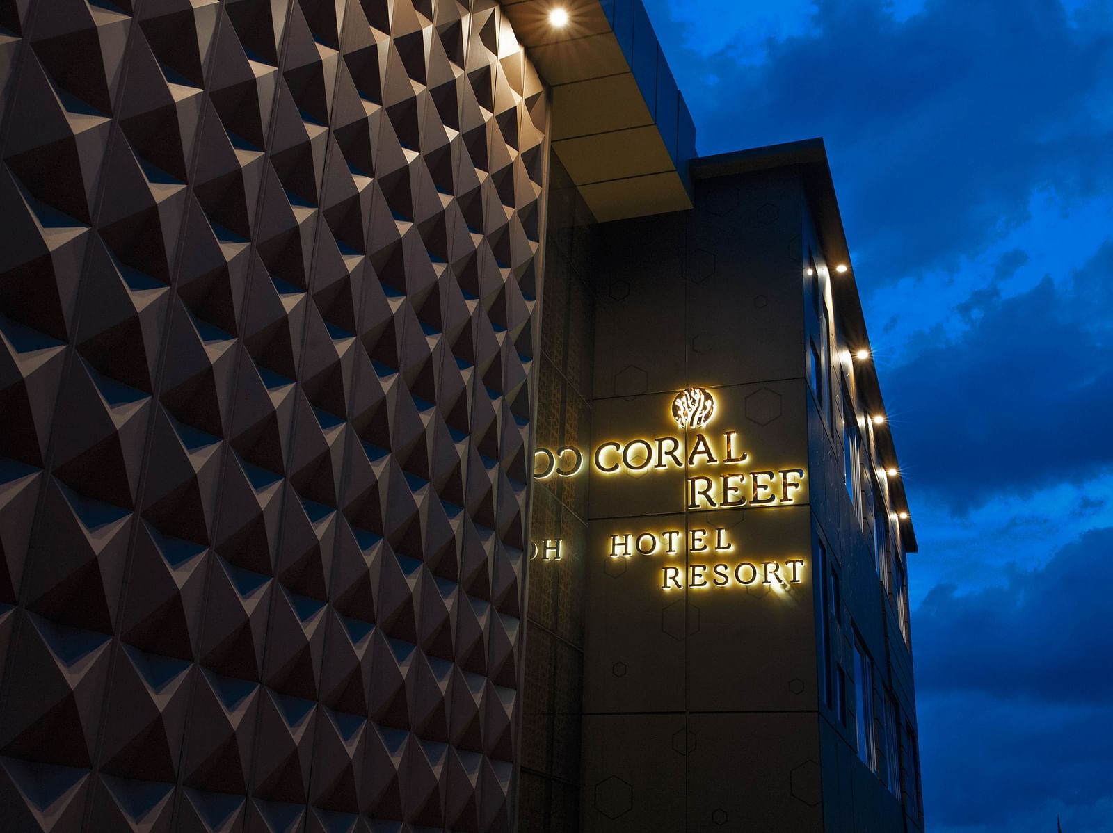 Image of facade of Coral Reef Hotel and Spa in Port Blair in the late evening as the sky is indigo