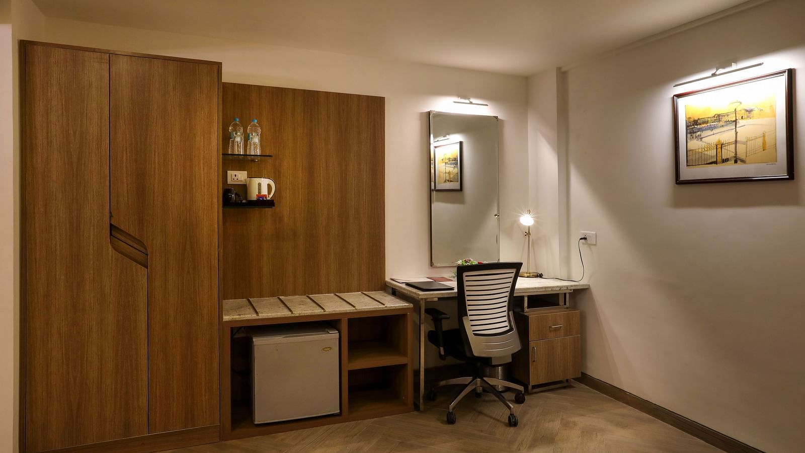 A room with a workdesk and a chair with paintings on the wall - Mango Hill Central, Chennai