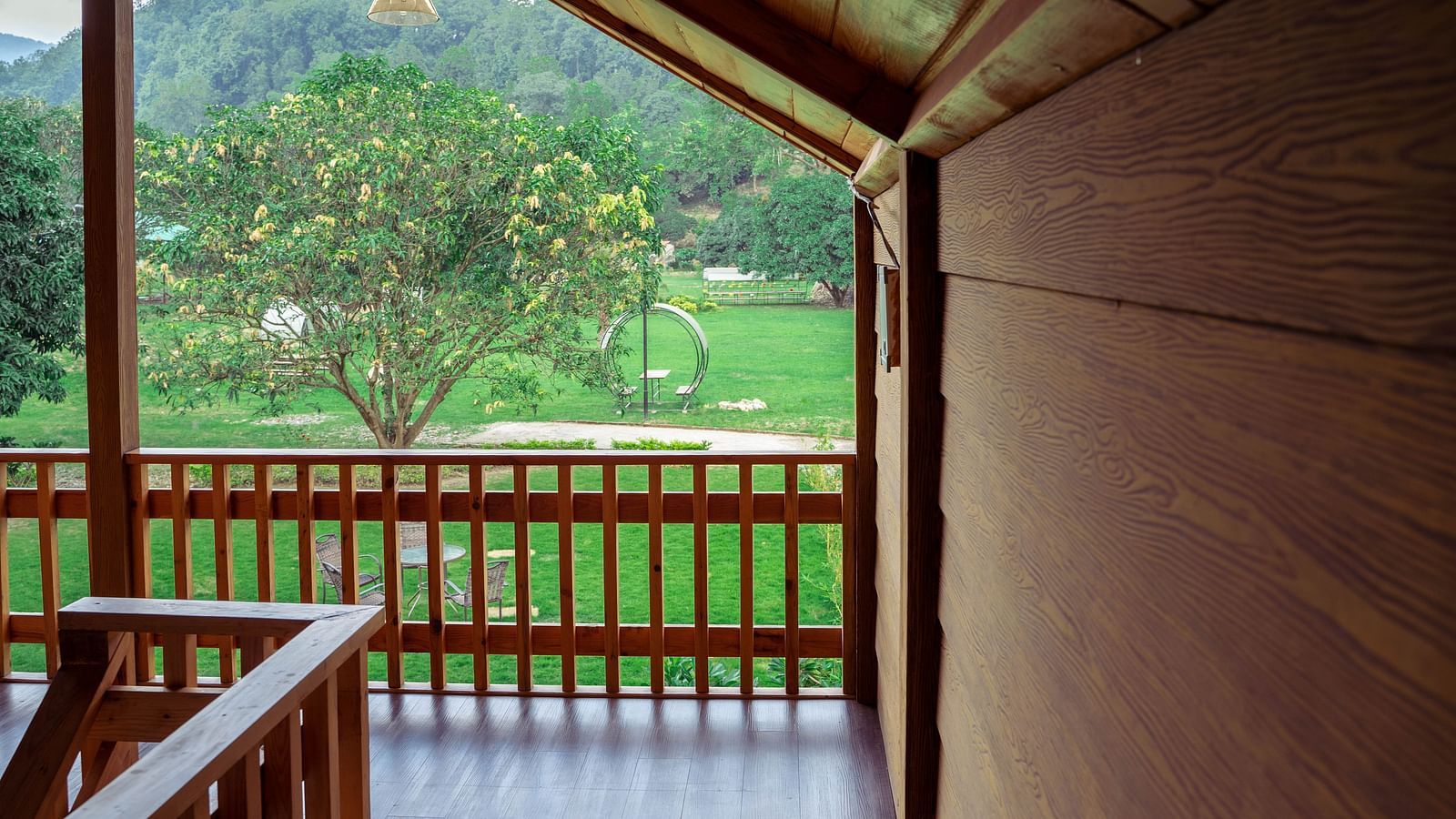 A view of the greenery through balcony at The Sylvan Retreat, Dehradun. 