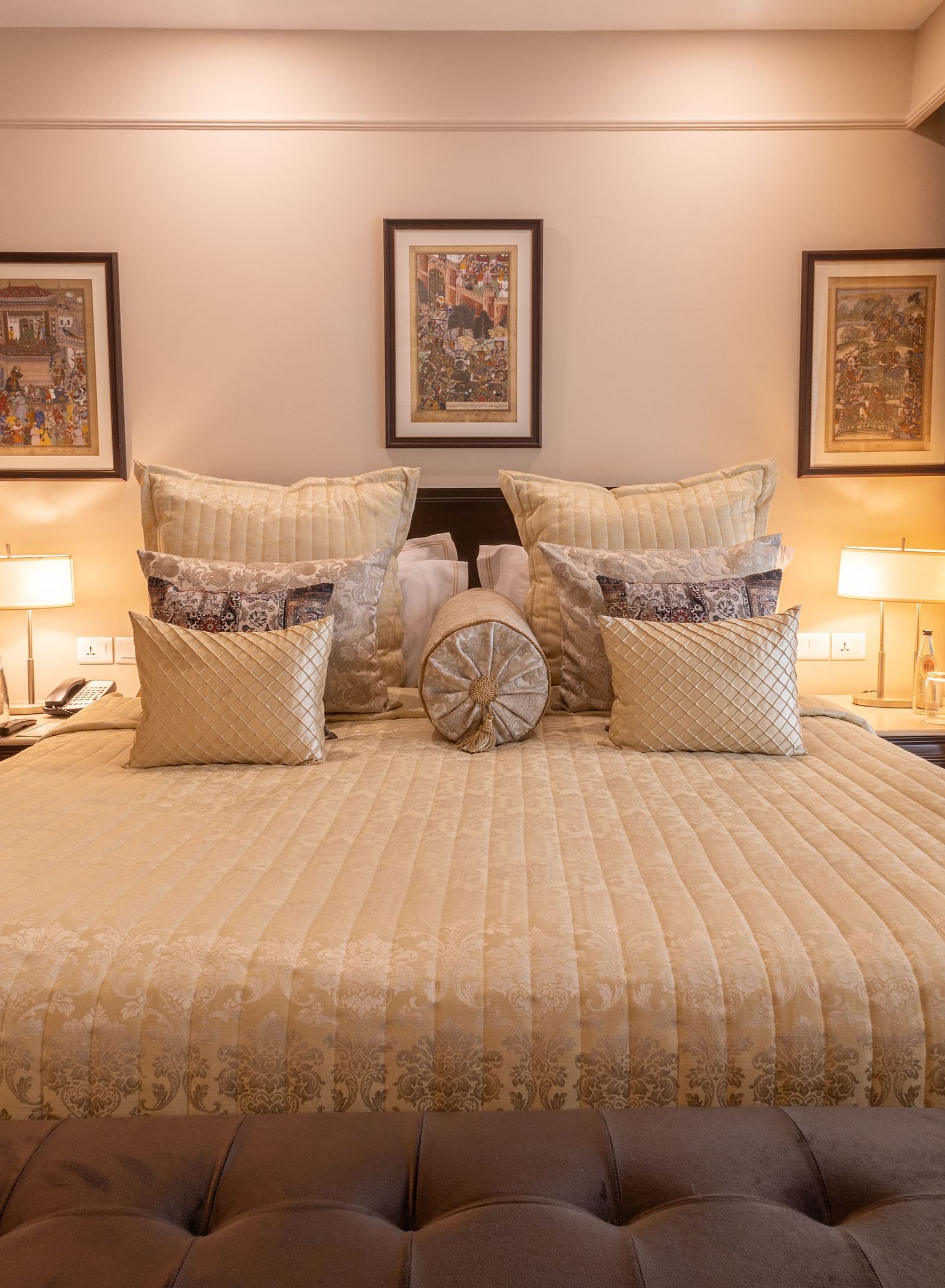 image of the king sized bed with three rectangular photo frames above the headboard of the bed at the heritage parlour room - The Claridges New Delhi