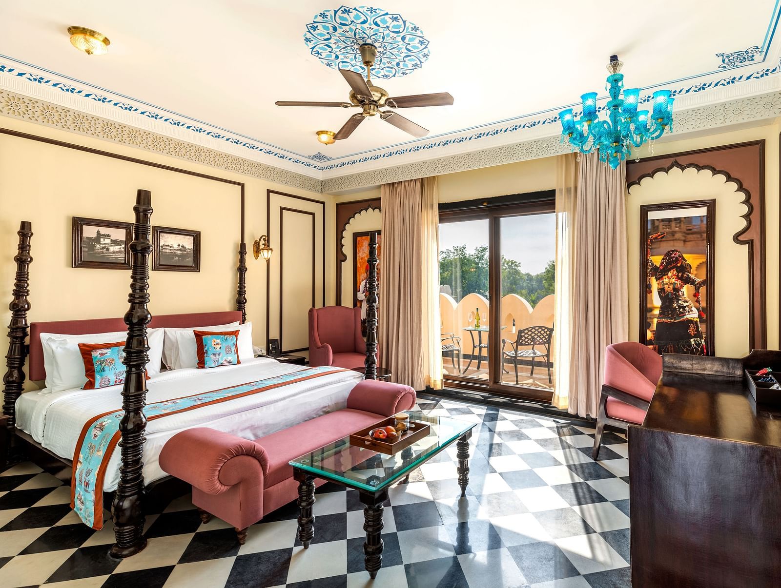 Royal suite with antique-style beds, chandeliers, and checkered flooring at Kesar Bagh Palace.
