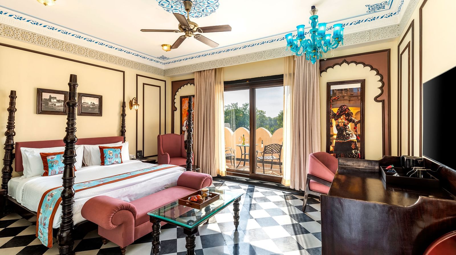 Royal suite with antique-style beds, chandeliers, and checkered flooring at Kesar Bagh Palace.
