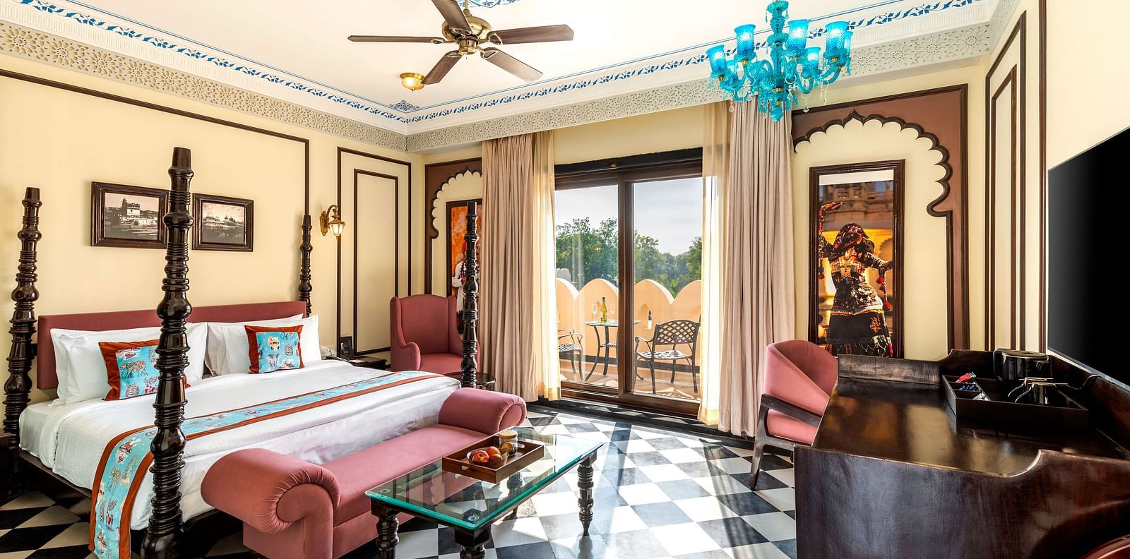 Royal suite with antique-style beds, chandeliers, and checkered flooring at Kesar Bagh Palace.
