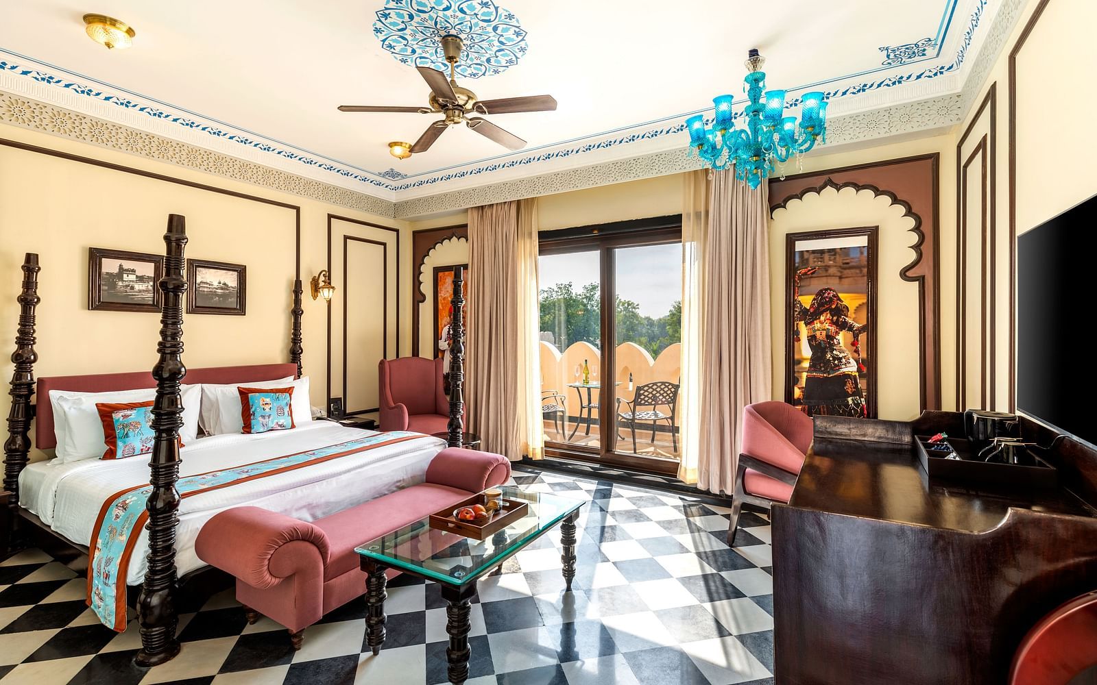 Spacious heritage suiteroom with vintage furniture and turquoise chandelier at Kesar Bagh Palace.