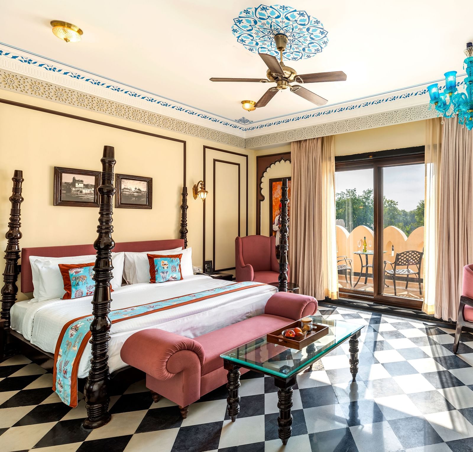 Spacious heritage suiteroom with vintage furniture and turquoise chandelier at Kesar Bagh Palace.