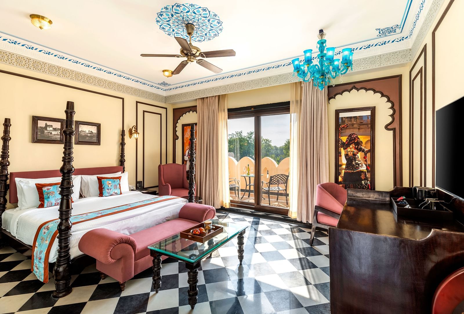 Royal suite with antique-style beds, chandeliers, and checkered flooring at Kesar Bagh Palace.