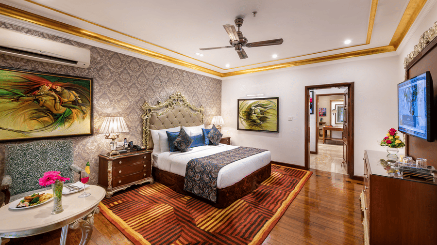 Well-appointed deluxe room with wooden flooring and warm decor at Mayfair Lagoon, Bhubaneswar