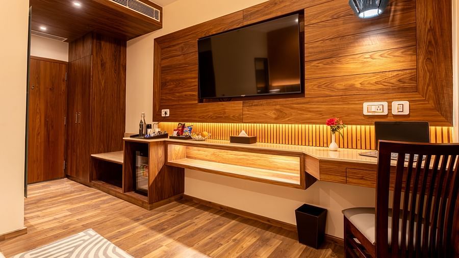 An image of a deluxe room with a flat screen TV, work desk and a chair - The Belvedere Himalayan Retreat, McLeodganj