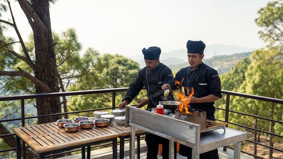 Two chefs cooking on a terrace at BluSalzz Escapade Resort, Lansdowne