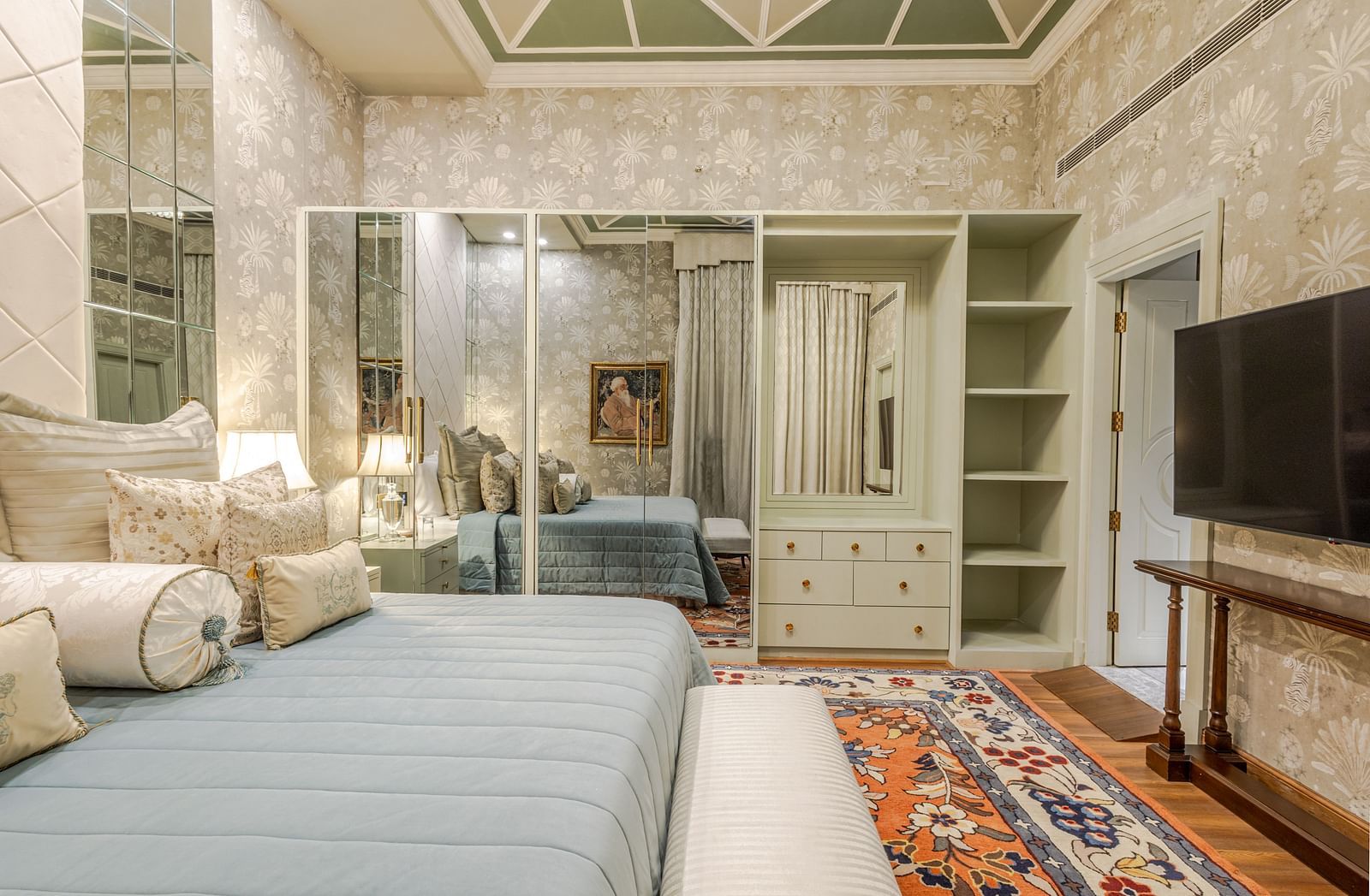 image of the bedroom from the side angle with a full length mirror attached to the spacious closet at our heritage luxury suite - The Claridges New Delhi