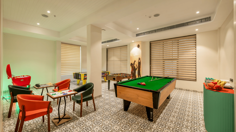 Games Room with comfortable seating and a foosball table at Lords Inn Somnath, offering a relaxed space for recreation and leisure.