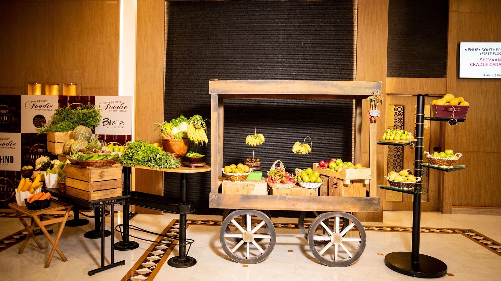 A cart with different kinds of fruits on it at Grand Chennai By GRT Hotels.