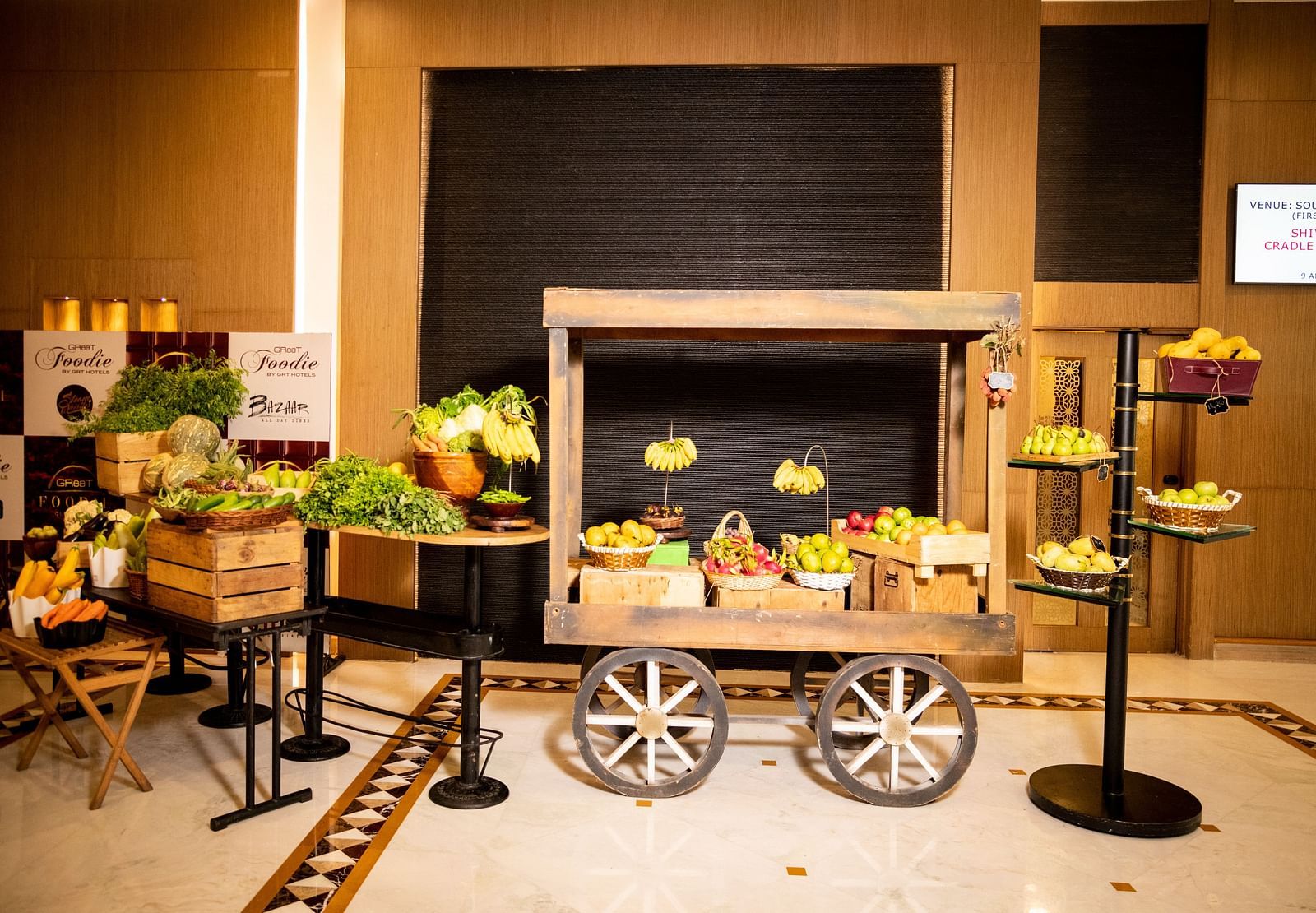 A cart with different kinds of fruits on it at Grand Chennai By GRT Hotels.