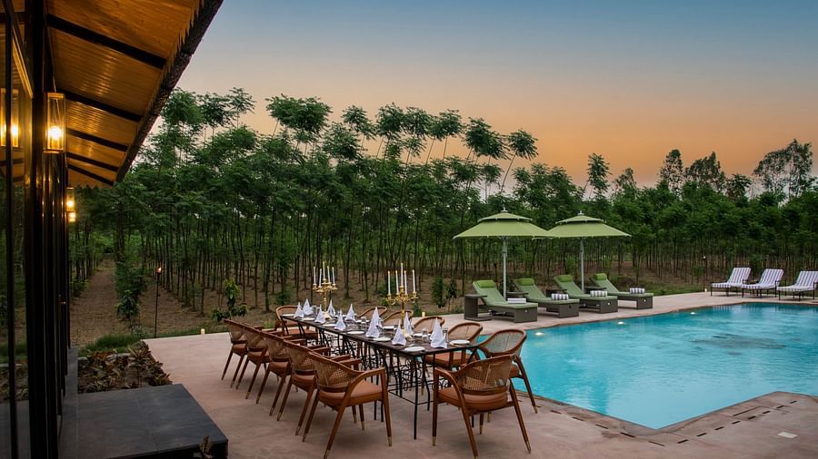 outdoor dining setting with swimming pool view - Aalia Jungle Resort & Spa