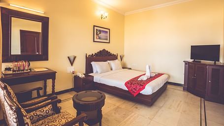 Standard Room at Paradise Isle Beach Resort, Udupi with a double bed and a work desk and chair