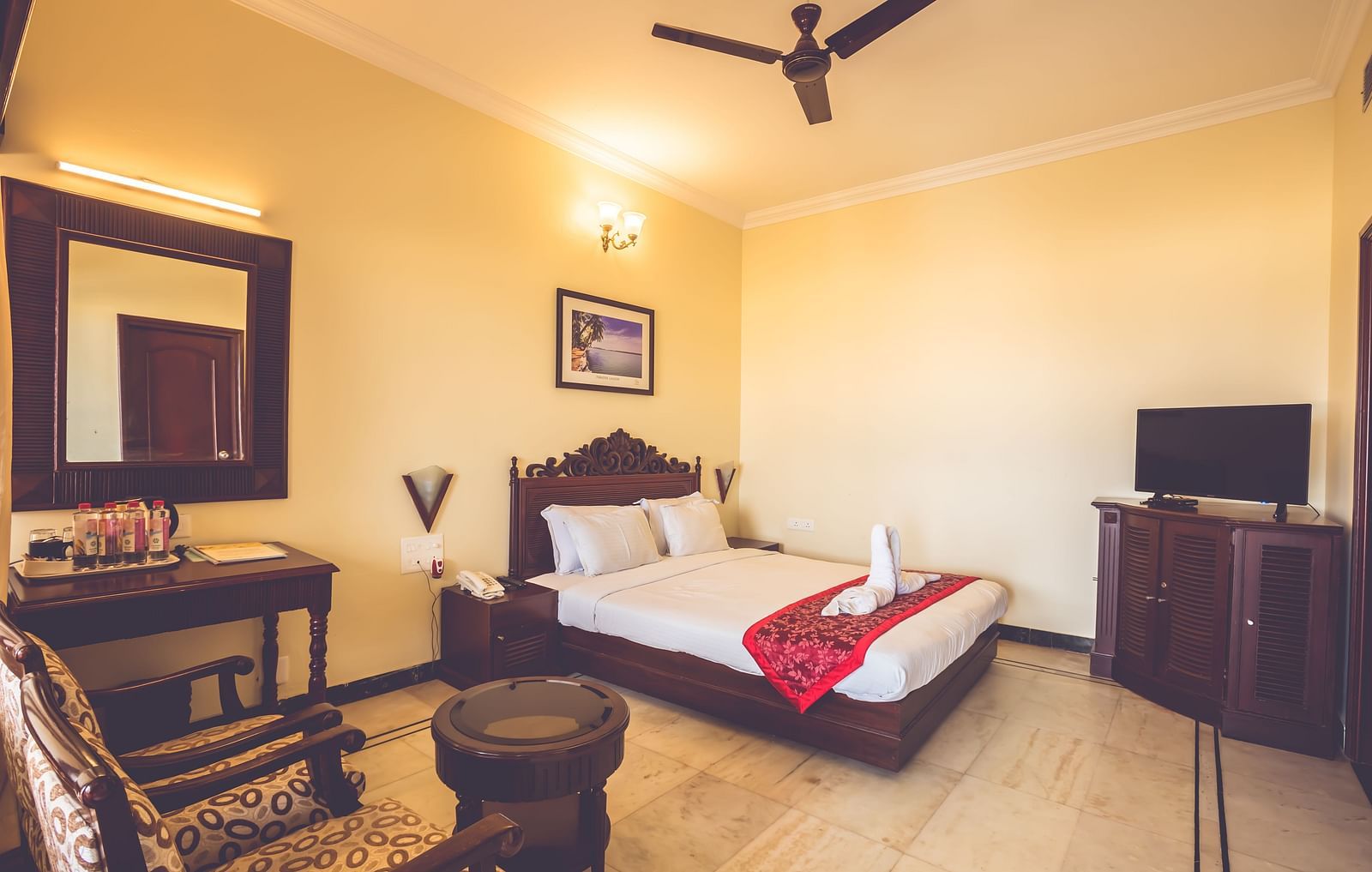 Standard Room at Paradise Isle Beach Resort, Udupi with a double bed and a work desk and chair