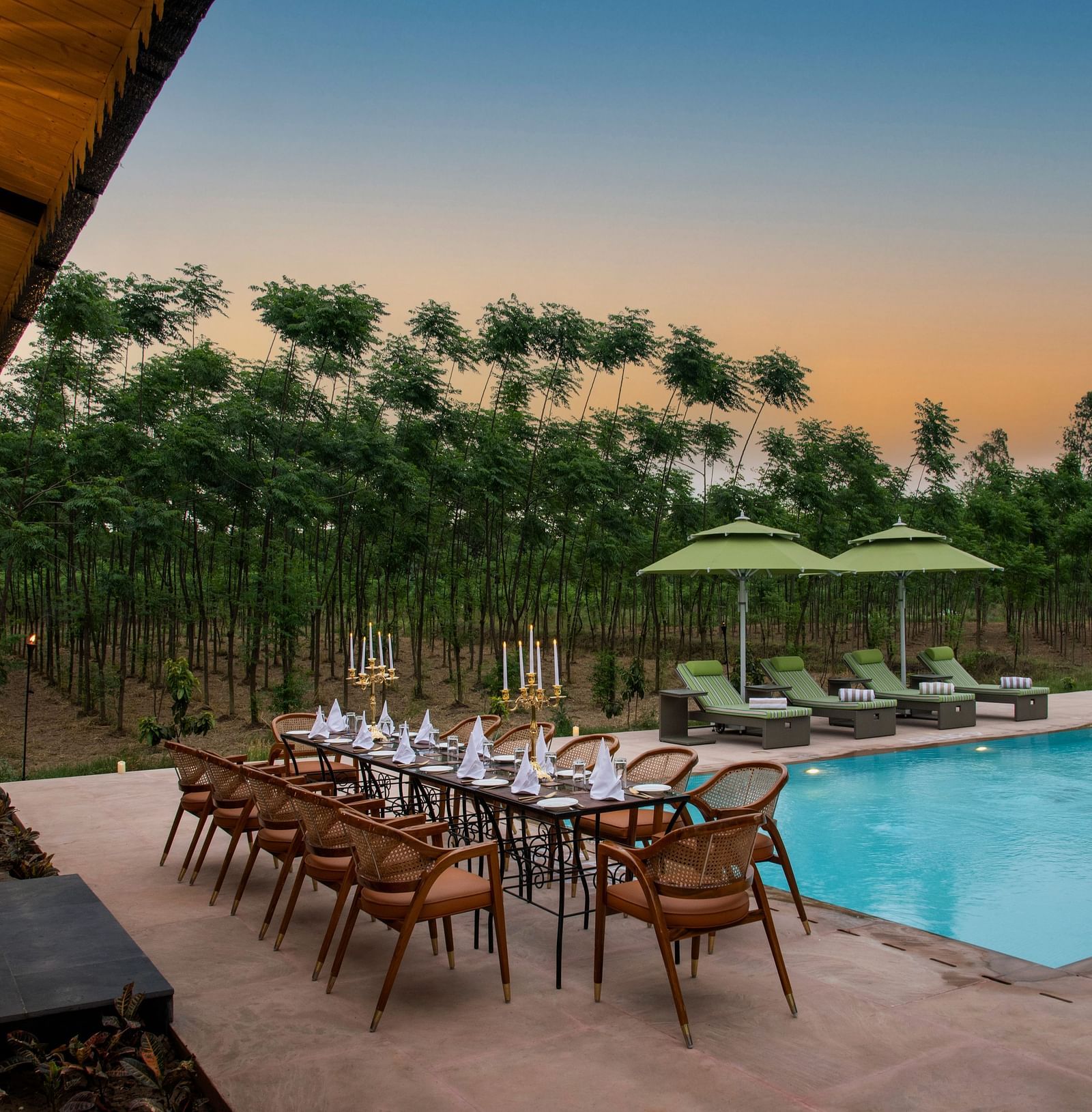 outdoor dining setting with swimming pool view - Aalia Jungle Resort & Spa