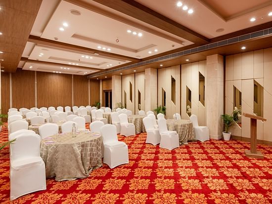 Round table seating arrangements inside the Banquet hall - The Orchid Hotel, Jamnagar