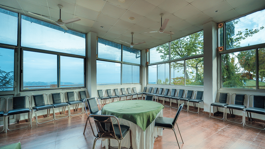 tables and chairs placed in the event venue at Flutter Hotels & Resorts surrounded by beautiful view of the valleys
