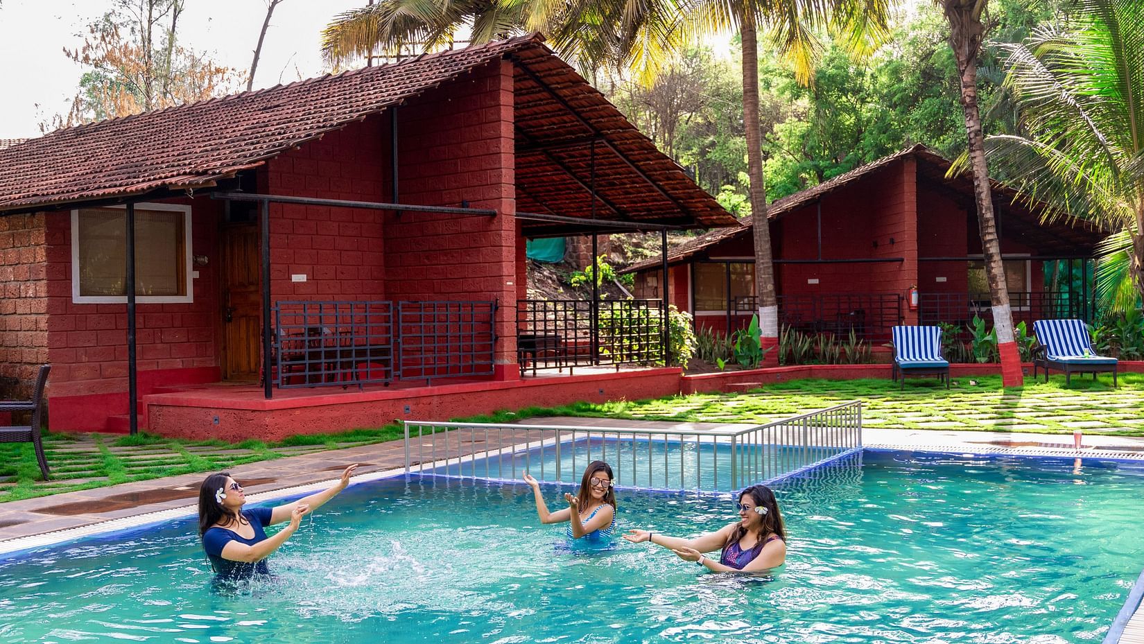 women playing in the swimming pool at Lotus Eco Beach Resort.