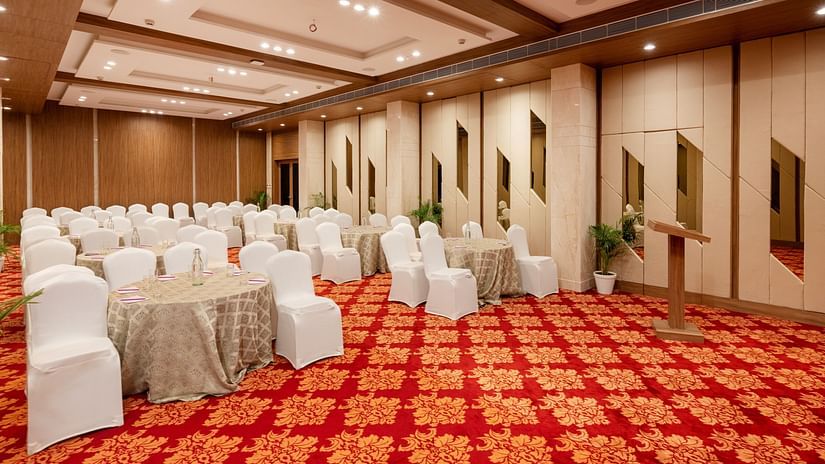 Round table seating arrangements inside the Banquet hall at The Orchid Hotel, Jamnagar