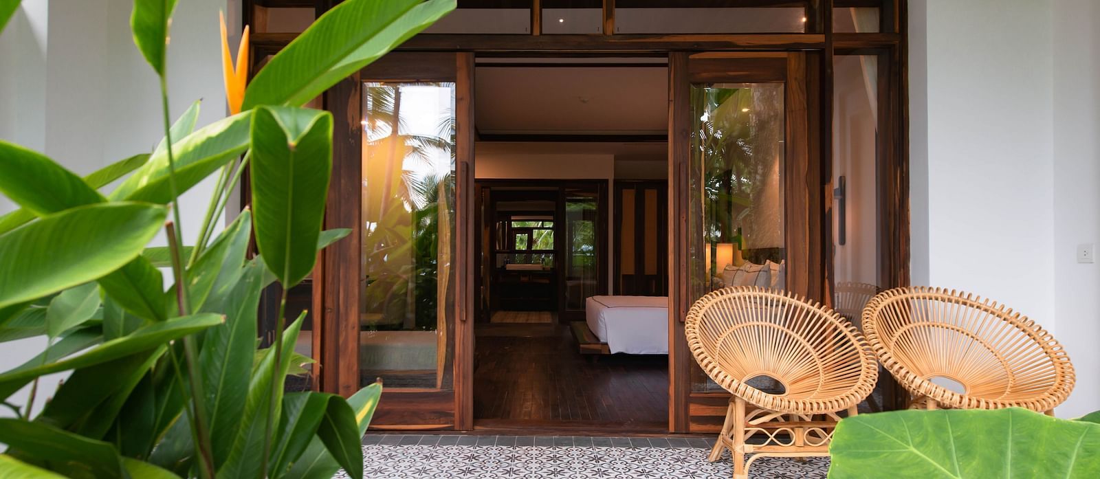 Another view of a balcony with a wooden chair to sit and relax and enjoy the garden view - Alibu Reosrt Nha Trang