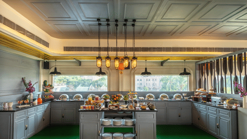 A restaurant with a spacious buffet area featuring a variety of food stations and tables set for dining.