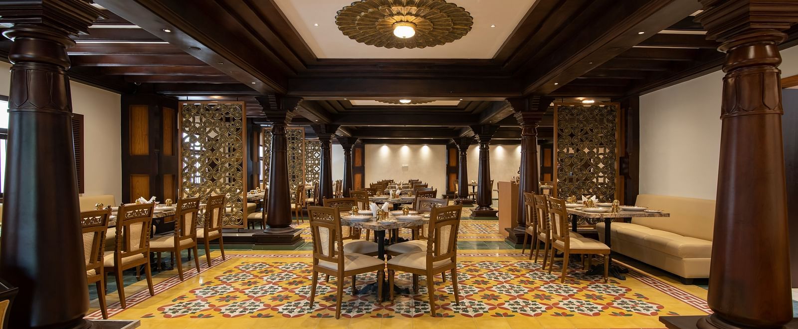 An image of long shot of  classic-themed dining space with seating arrangements  - The President Hotel, Kumara Park, Bangalore