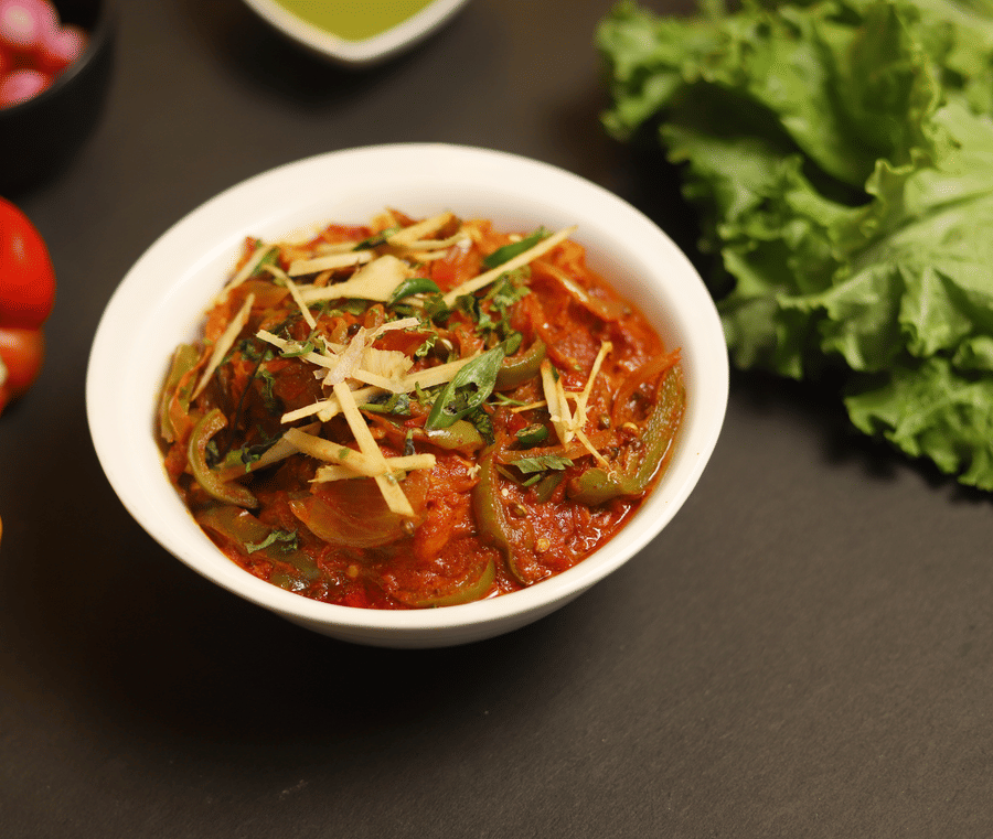 A dish made with onion and capsicum and garnished with coriander leaves at a restaurant in Five Elements Hotels North Avenue, Delhi
