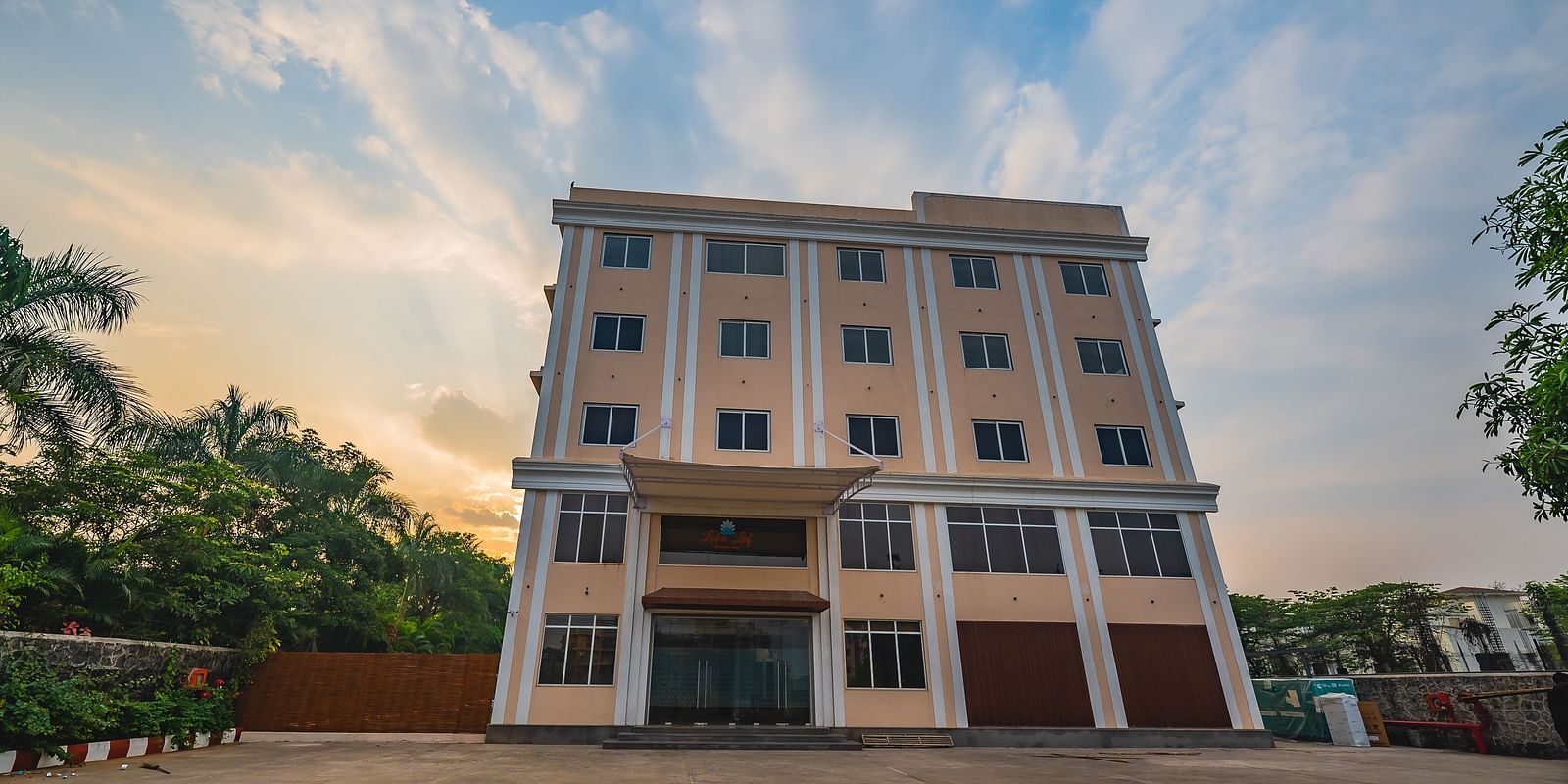 A modern multi-storey hotel building with a spacious outdoor area at Lotus Leaf Boutique Hotel.
